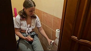 A girl fucks a guy in the ass in the toilet with a strap on