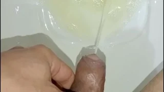Desperate young man pissing, morning erection, close-up